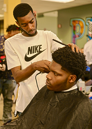 barbering student practicing on another student