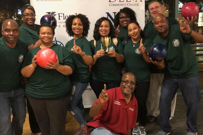 Delgado faculty and staff pose for a photo after winning a trophy at the "Bowling for a Cause" event.