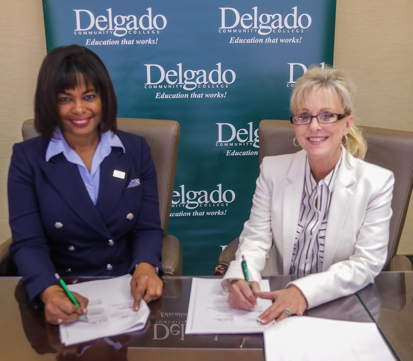 A new transfer agreement for Delgado Community College Business Administration graduates to earn bachelor’s degrees was signed by Delgado Chancellor Joan Davis, left, and Gina Fedell, right, Assistant Director for Academic Alliances in the Southern New Hampshire University College of Online and Continuing Education.