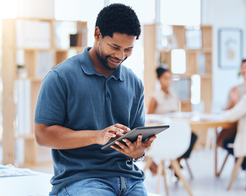 young black man planning on a tablet