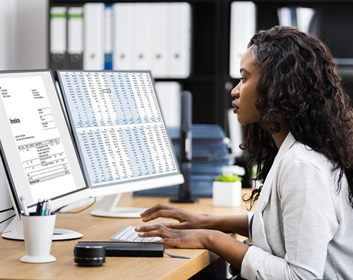 female at computer coding medical records