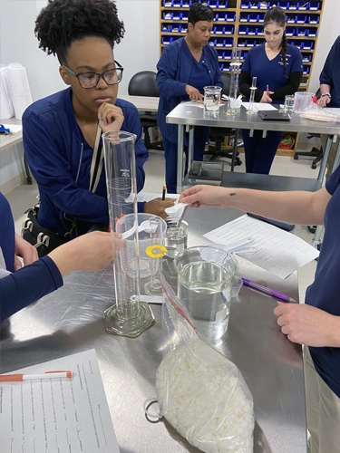 students measuring pills