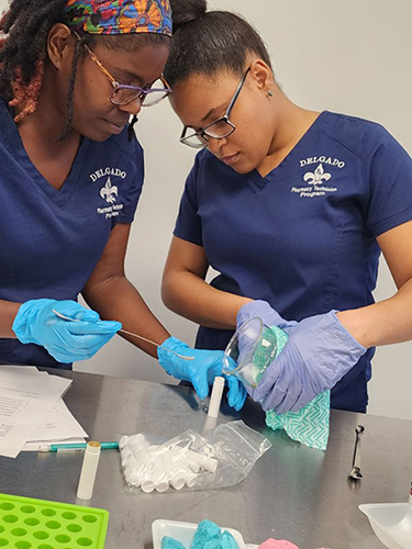 students measuring pills in a container