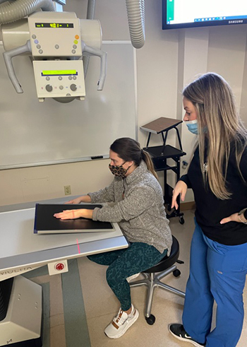 student working on a x-ray machine