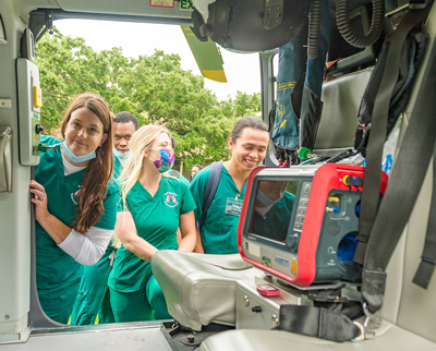 students looking inside a hospital helicopter