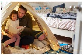 father reading to daughter