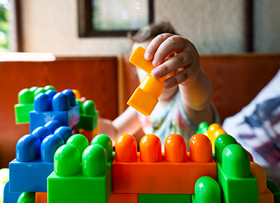 infant playing with blocks