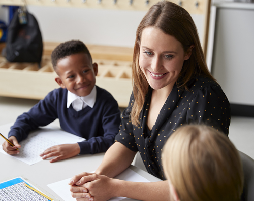 teacher with two elementary students