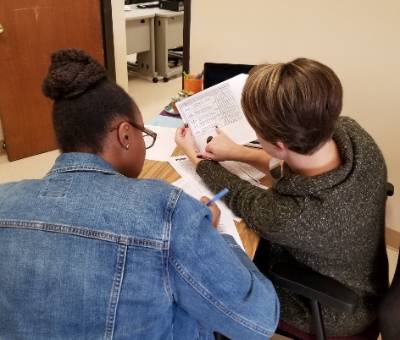 writing coach working with student