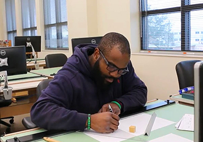 CADD student at a desk working on a project