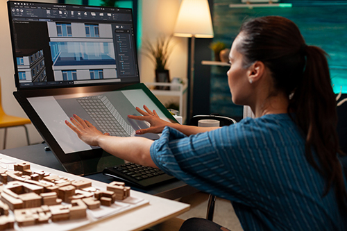 female designing a building on a computer