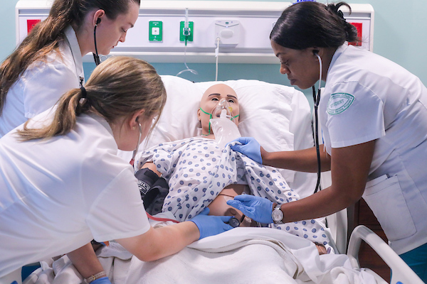 LPN students taking vitals on patient simulator