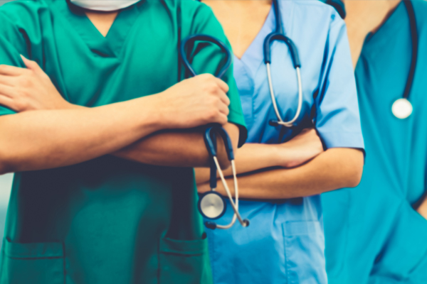 close up of 3 nurses focusing on their stethoscopes