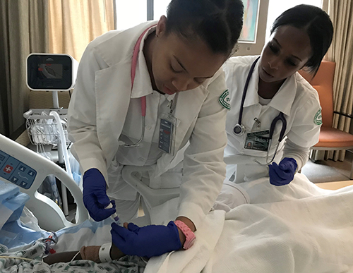 two female nurses giving an IV