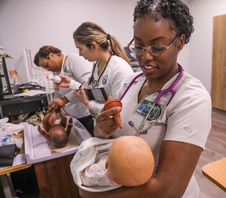 students working with infant simulators