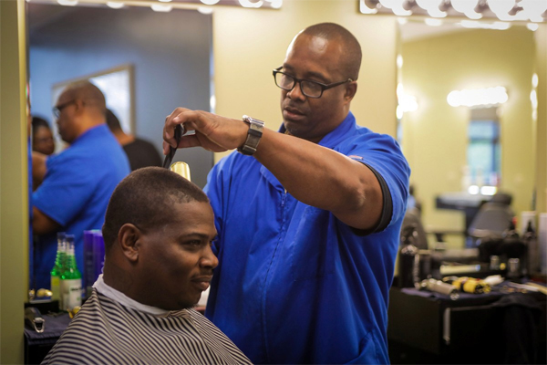 barbering student cutting hair