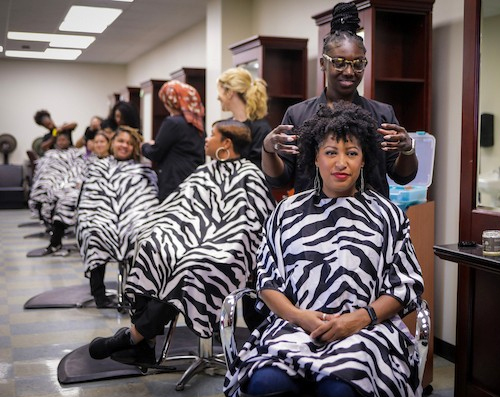 group of students practicing styling on other students
