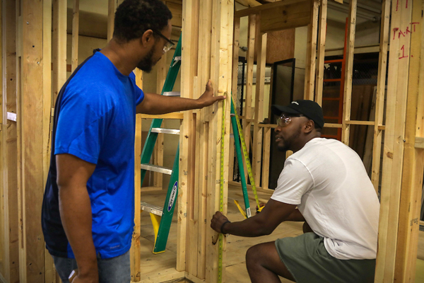 students framing a house