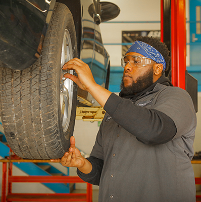 student working on a tire