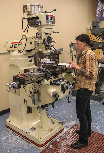 female student using percision machine