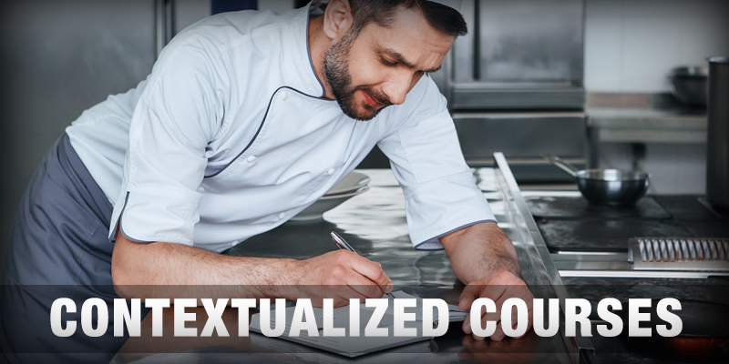 chef writing on a notepad in a kitchen