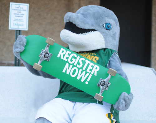 Delgado Dolphin holding a register now sign