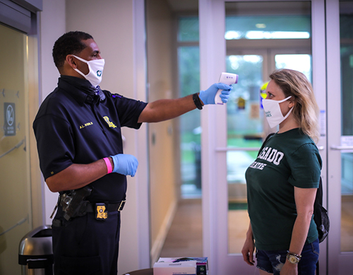 student getting temperature check