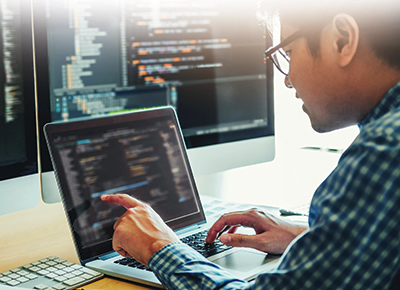 IT person working on a computer and network