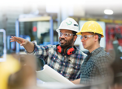 Guys in hard hats in a warehouse