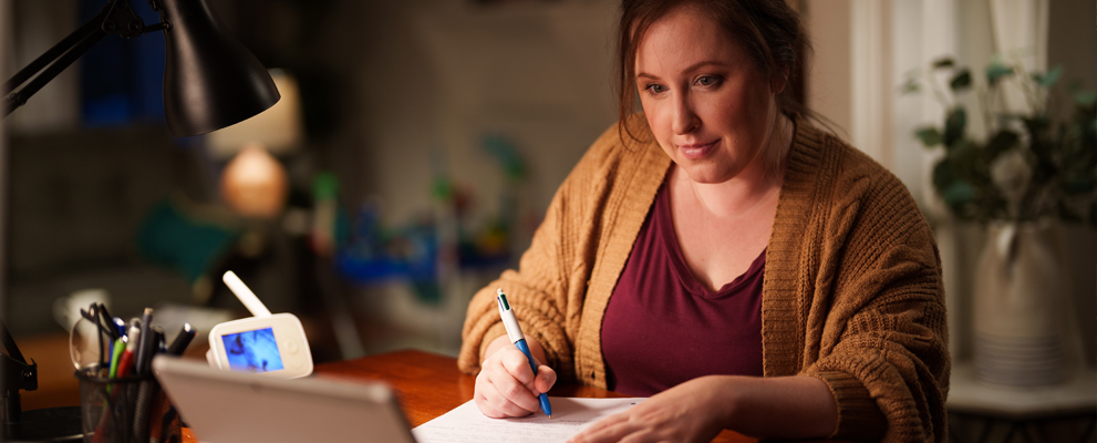 female at home at night working