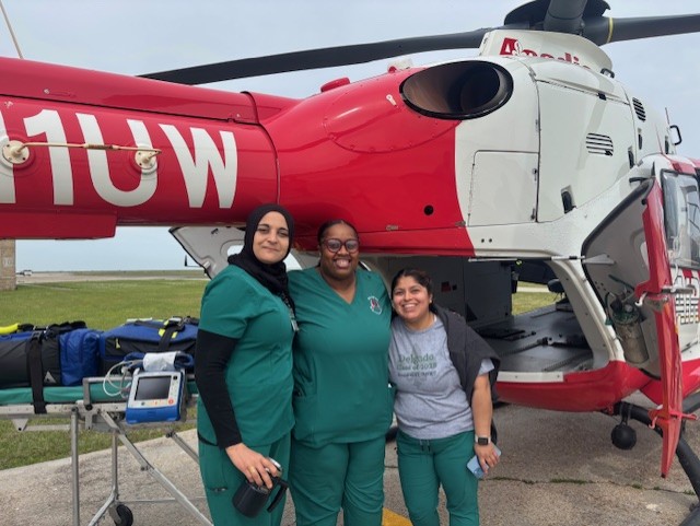 Students posing outside the helicopter