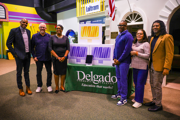 members of apple presenting computers to delgado