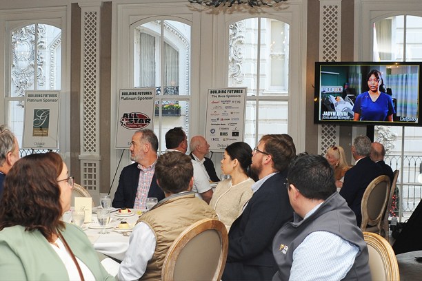 people watching a video at the luncheon