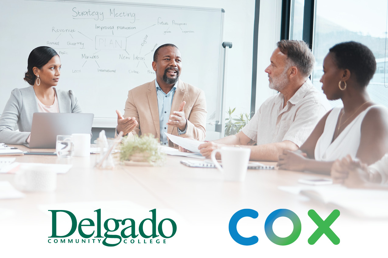 Stock image of business meeting with Delgado and Cox logos