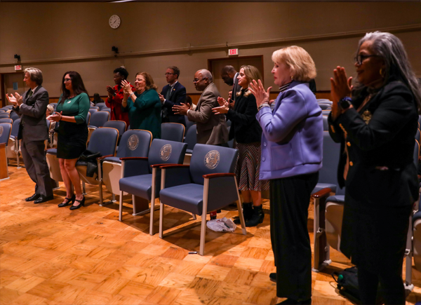 Delgado employees standing and applauding