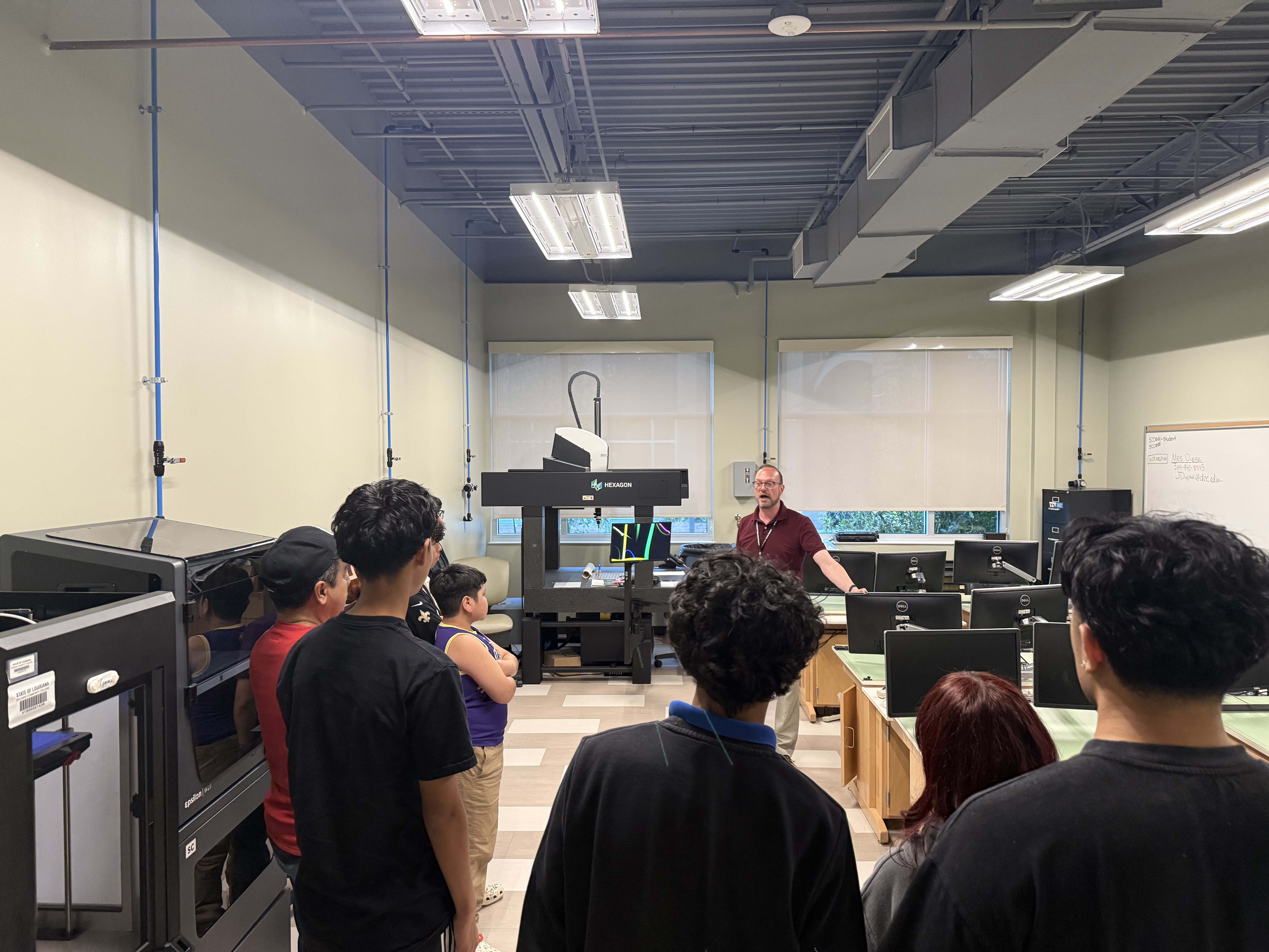 Dual enrollment students listen to a presentation during the open house