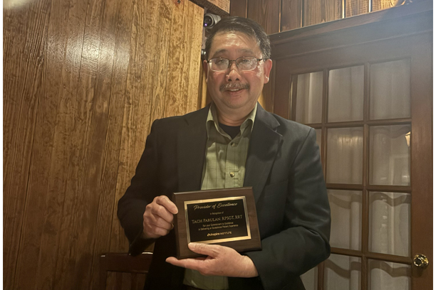Taciano Parulan holding an award