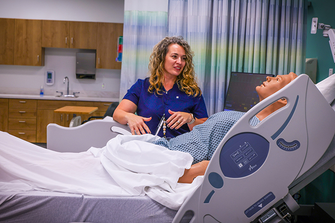 student nurse attending to a dummy