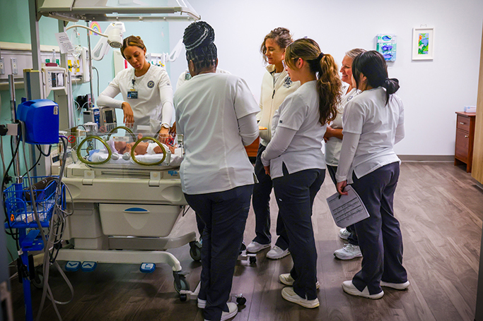 student nurses attending to a child dummy