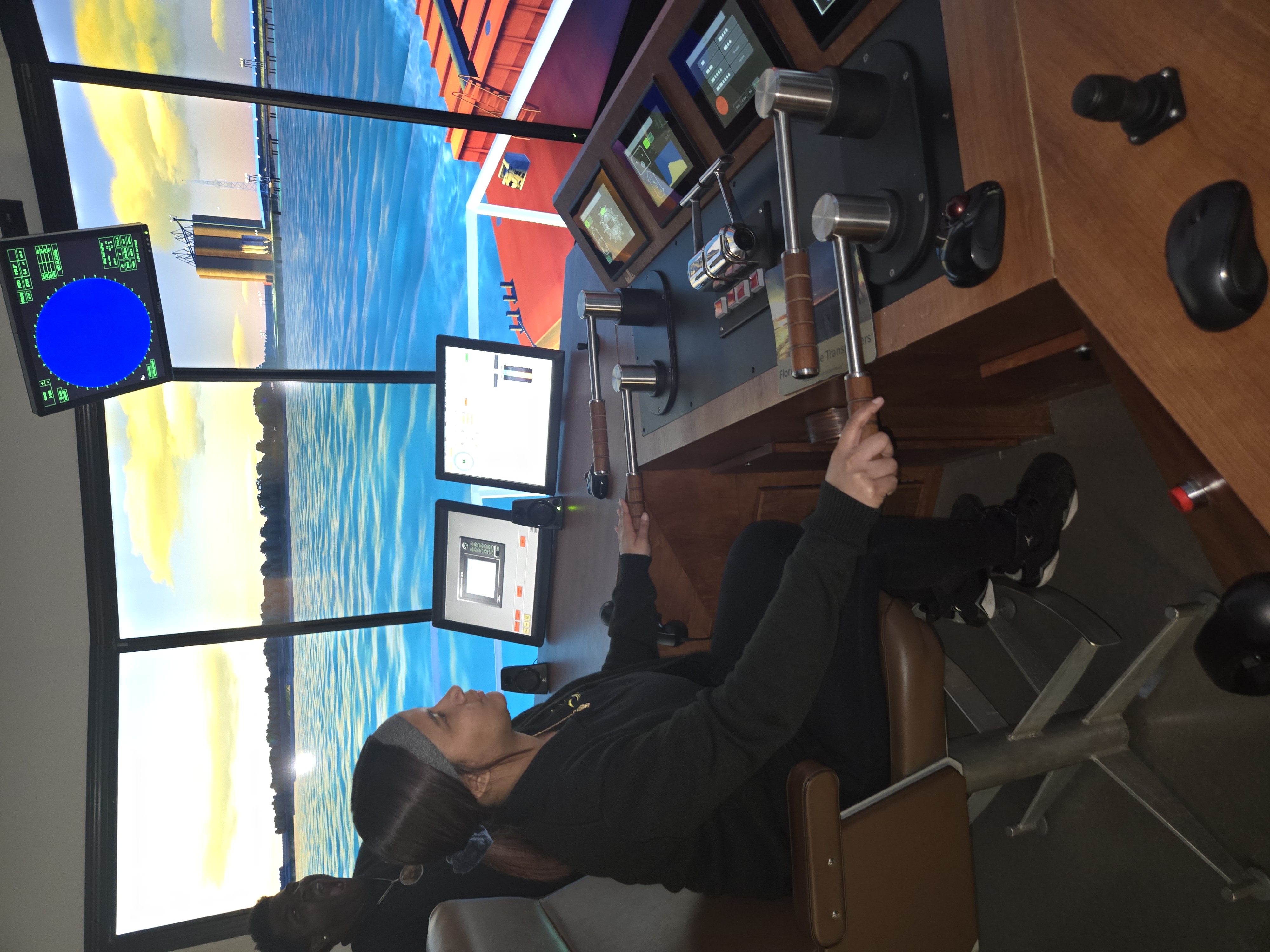 A Young Audiences Charter School student uses a maritime simulator