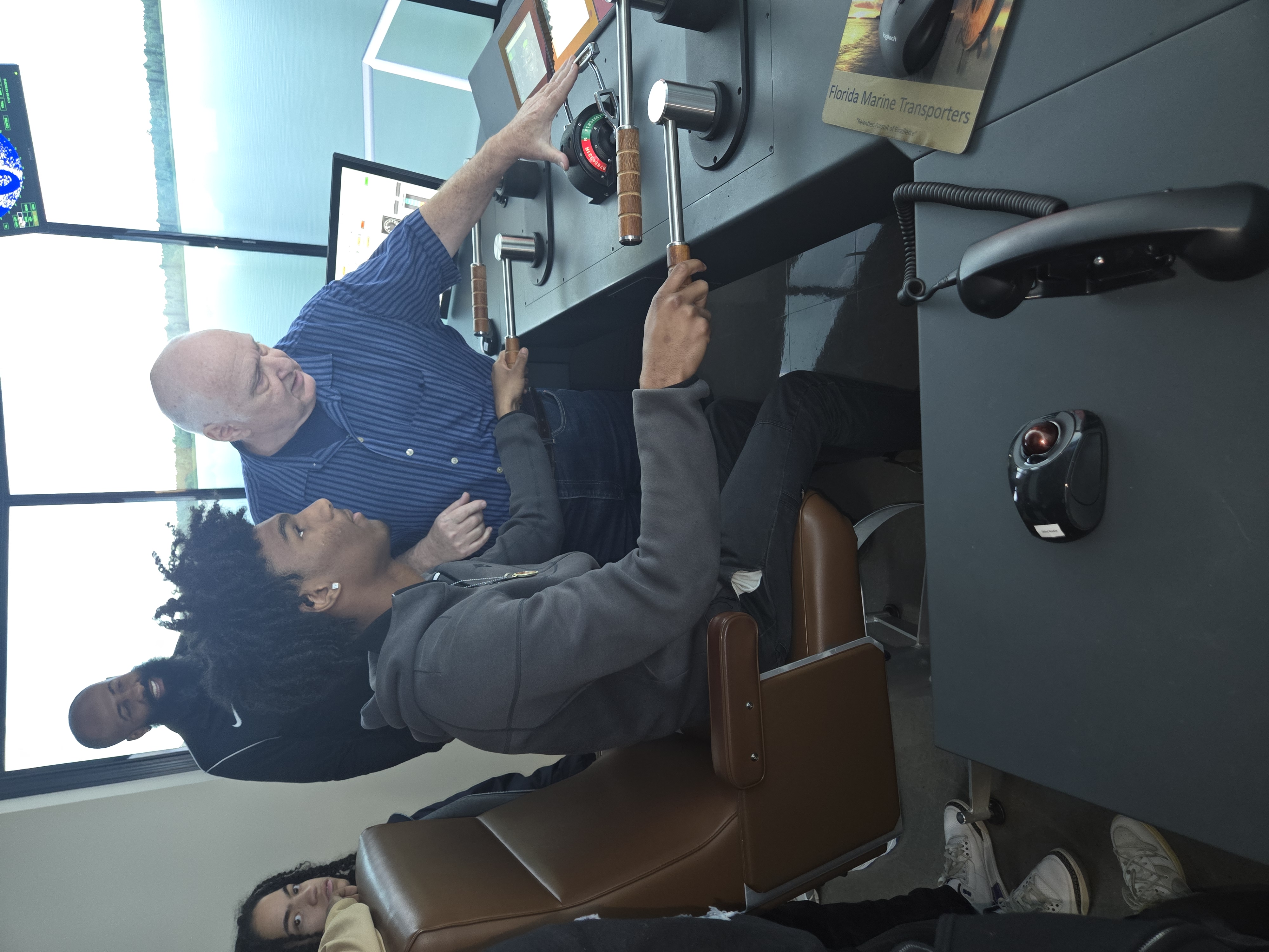 A charter school student uses a maritime simulator