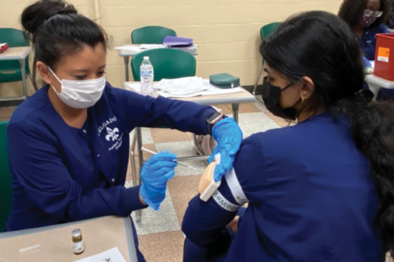 Pharmacy technician students practice administering vaccines