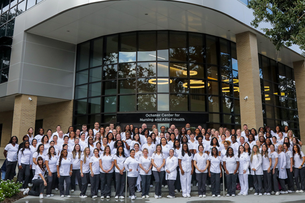 RN students in front of the new Ochsner Center for Nursing and Allied Health building