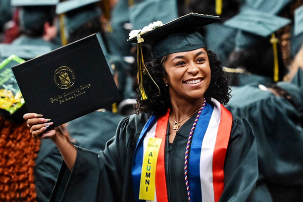 Graduate holding up diploma