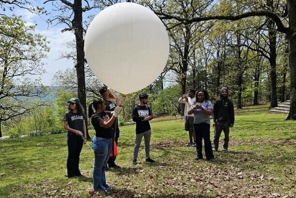 Delgado students prepare to launch a balloon. 