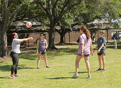 female student playing volleyball