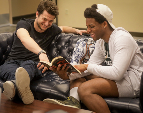 two male student laughing