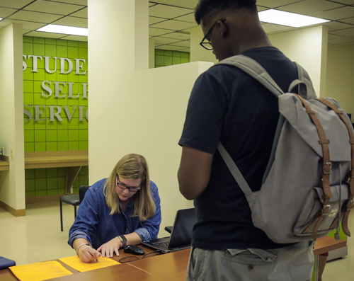 student getting assistance at the registrar office