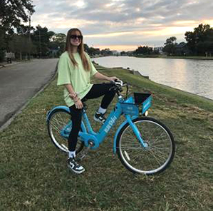 female on blue bike