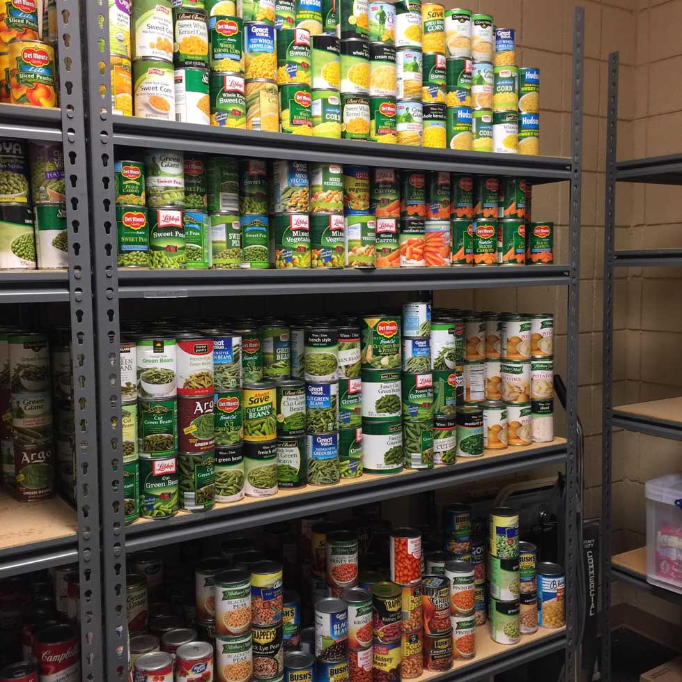 Hundreds of canned goods sit on a shelf in the Single Stop food pantry.